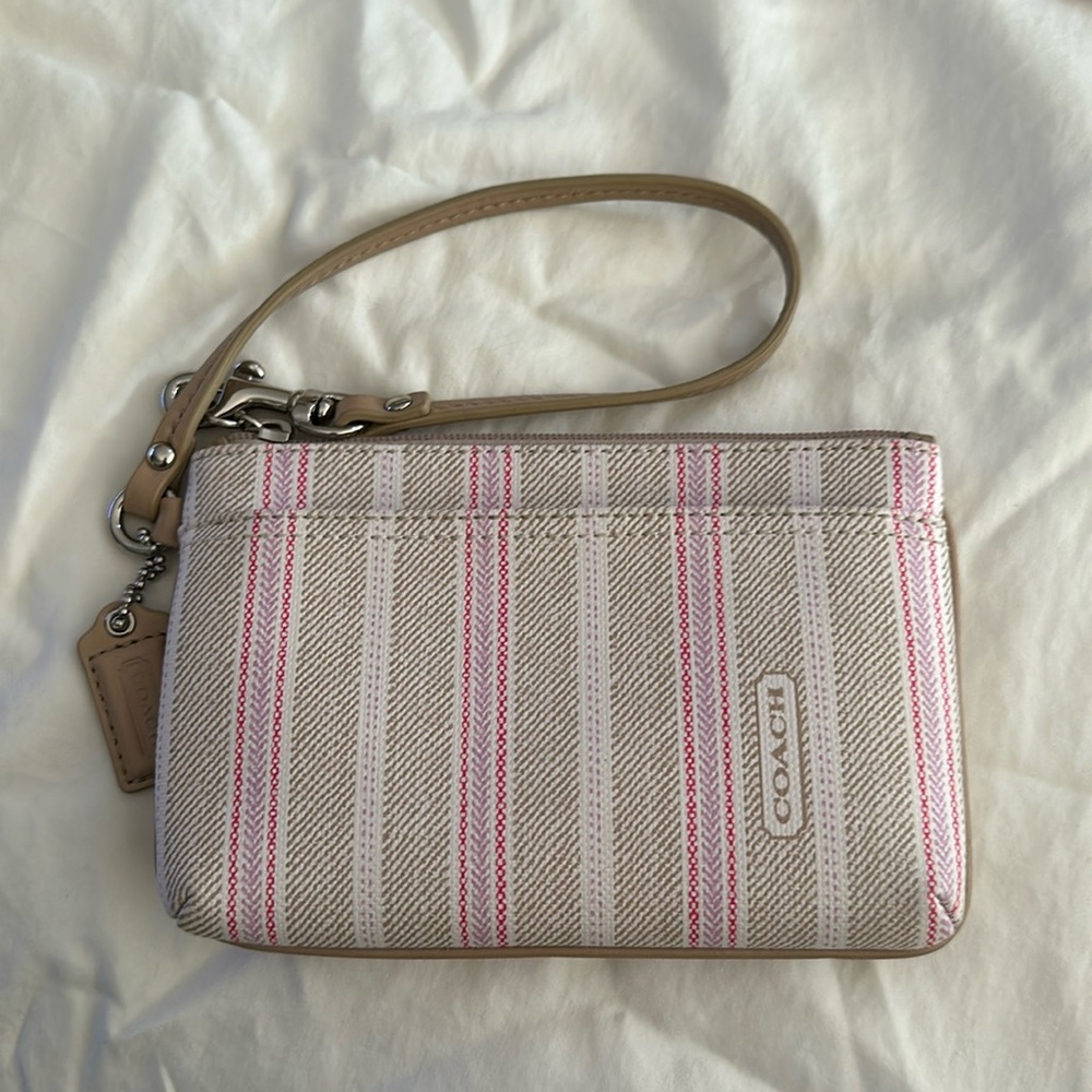 Coach wristlet in taupe and pink stripe vinyl with silk lining.